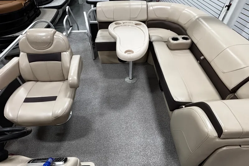 Slide: The Image of 2018 Sun Tracker Party Barge 20 DLX interior with beige seating and table. - 6