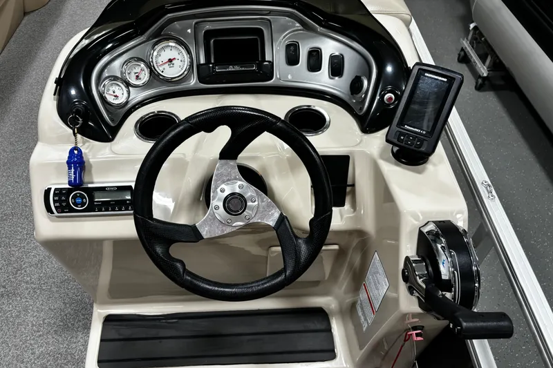 Slide: The Image of 2018 Sun Tracker Party Barge 20 DLX dashboard with steering wheel and control panel. - 7