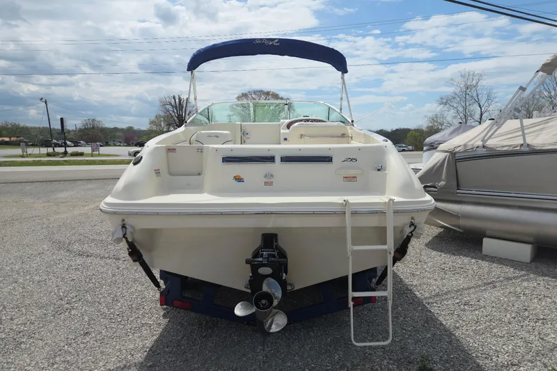Slide: The Image of 2000 Sea Ray 215 Express Cruiser boat, rear view with ladder and canopy. - 2