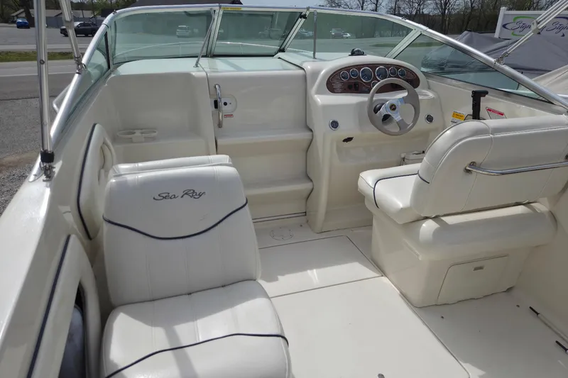 Slide: The Image of 2000 Sea Ray 215 Express Cruiser interior with steering wheel and seating. - 3