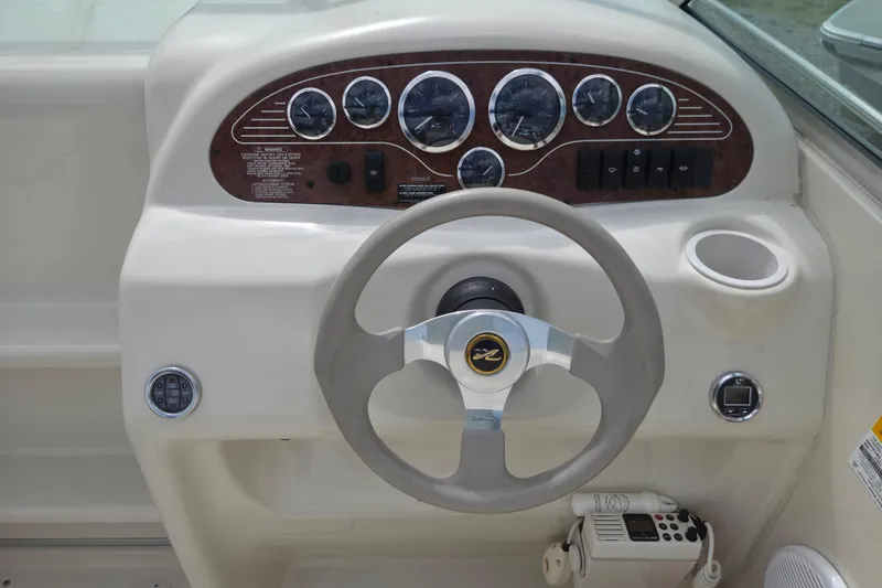 Slide: The Image of Steering console of a 2000 Sea Ray 215 Express Cruiser with gauges and controls. - 5