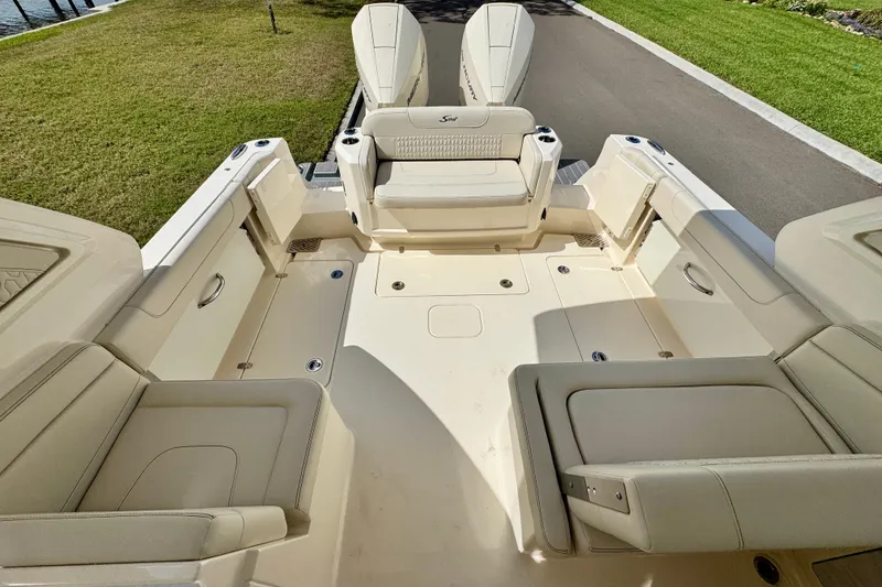 Slide: The Image of 2027 Scout 288 Dorado boat interior with beige seating and spacious deck layout. - 15