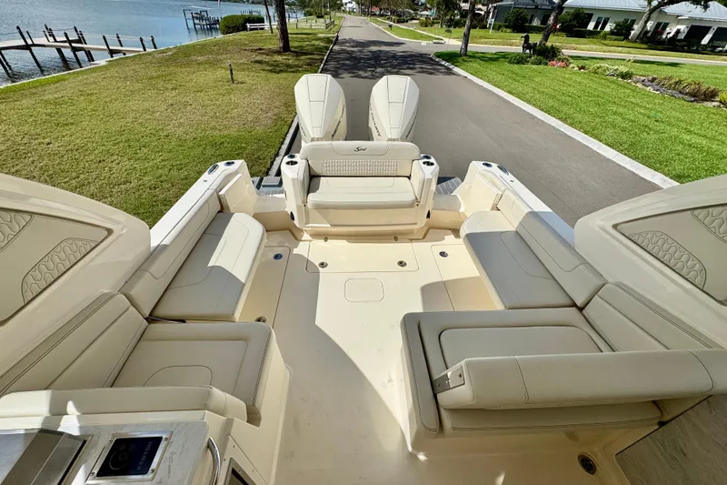 Slide: The Image of 2027 Scout 288 Dorado boat interior with luxurious seating and waterfront view. - 16
