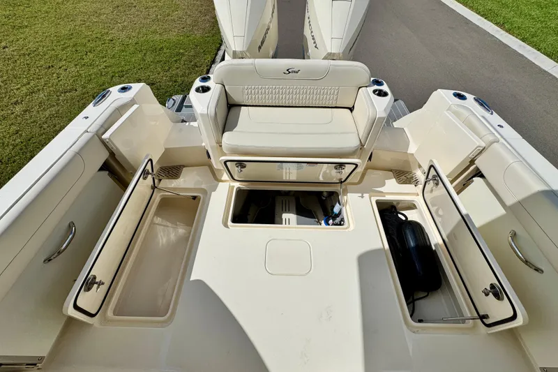 Slide: The Image of 2027 Scout 288 Dorado boat deck with open storage compartments and seating. - 17