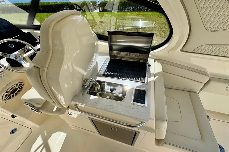 Slide: The Image of 2027 Scout 288 Dorado boat interior with grill, sink, and luxurious seating. - 19