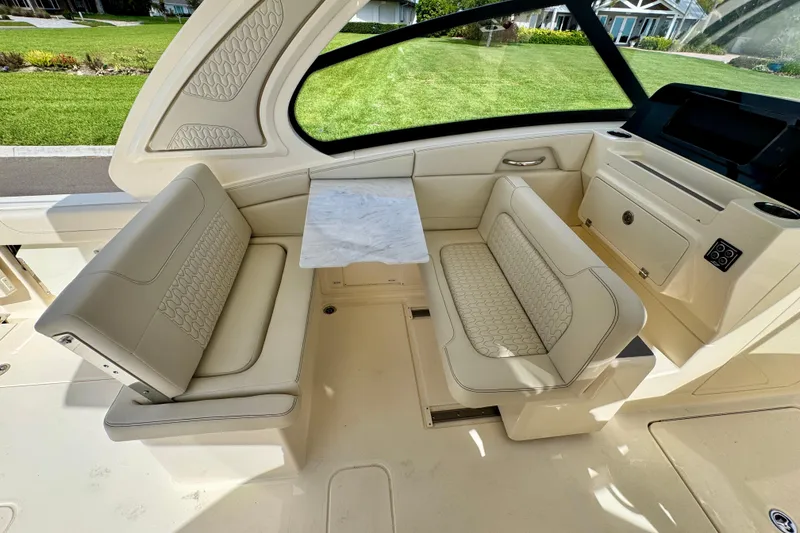 Slide: The Image of Luxurious interior of 2027 Scout 288 Dorado boat with elegant seating and table. - 22