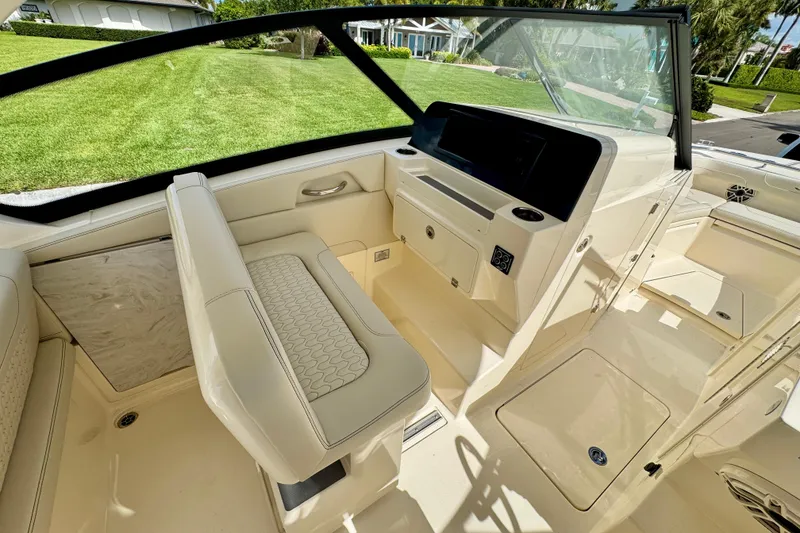 Slide: The Image of 2027 Scout 288 Dorado boat interior with luxurious seating and modern dashboard. - 24