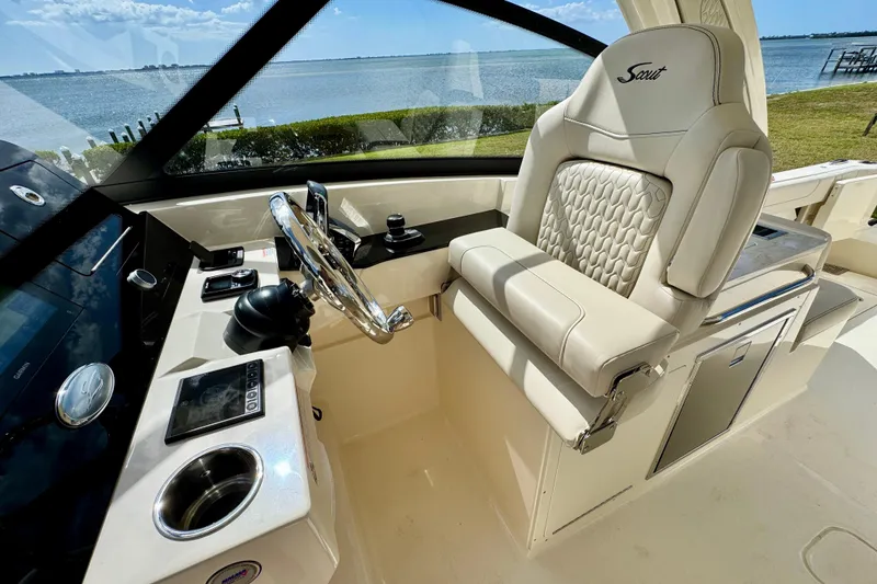 Slide: The Image of Luxurious helm of 2027 Scout 288 Dorado boat with leather seating and modern controls. - 30