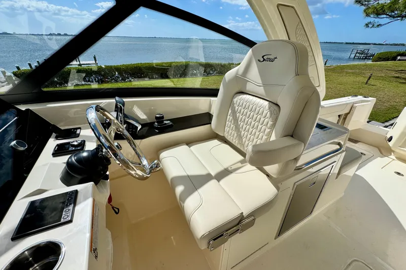 Slide: The Image of Luxurious interior of 2027 Scout 288 Dorado boat with plush seating and scenic water view. - 31