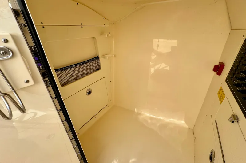 Slide: The Image of Interior cabin of 2027 Scout 288 Dorado boat, featuring storage and control panel. - 42