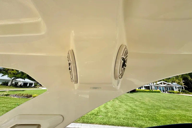 Slide: The Image of 2027 Scout 288 Dorado boat speakers on deck, with a scenic background. - 48