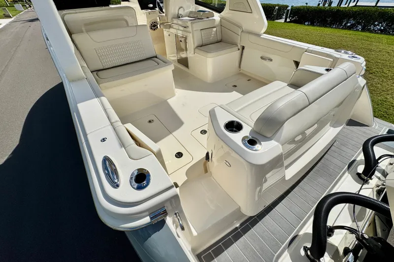 Slide: The Image of 2027 Scout 288 Dorado boat interior with seating and cup holders, docked near water. - 5