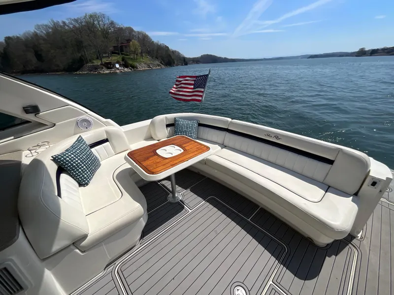Slide: The Image of 2006 Sea Ray 48 Sundancer yacht with seating area and American flag on a sunny day. - 19
