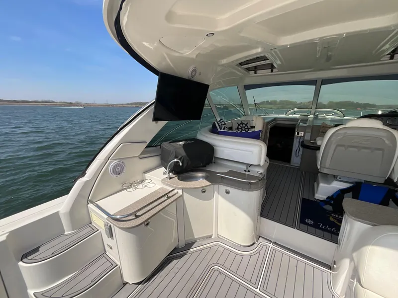 Slide: The Image of 2006 Sea Ray 48 Sundancer yacht interior with seating, TV, and water view. - 20