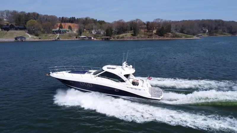 Slide: The Image of 2006 Sea Ray 48 Sundancer cruising on a scenic lake. - 3