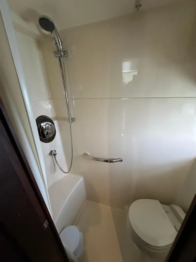 Slide: The Image of Bathroom interior of 2006 Sea Ray 48 Sundancer yacht, featuring shower and toilet. - 31