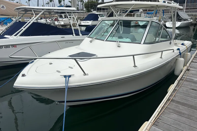 Slide: The Image of 2007 Pursuit 235 Denali LS boat docked at marina, side view. - 1