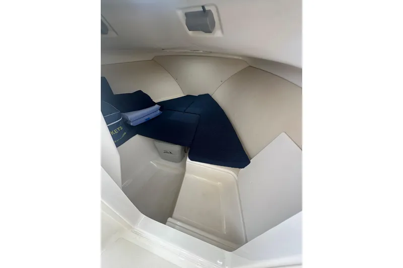 Slide: The Image of Interior cabin of 2007 Pursuit 235 Denali LS boat with blue cushions. - 11