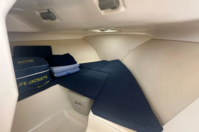 Slide: The Image of Interior cabin of 2007 Pursuit 235 Denali LS with life jackets and cushions. - 12