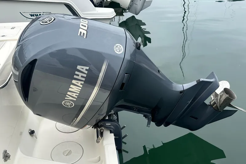 Slide: The Image of Yamaha 300 outboard motor on 2007 Pursuit 235 Denali LS boat, docked in calm water. - 15