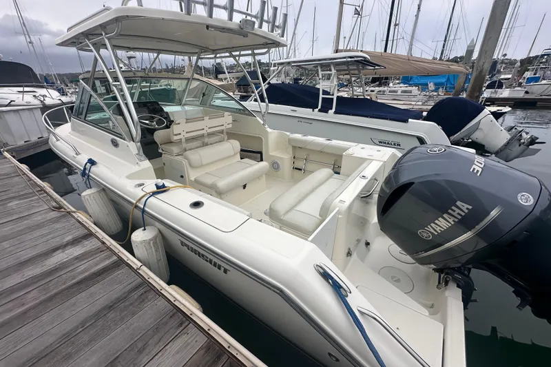 Slide: The Image of 2007 Pursuit 235 Denali LS boat docked, featuring Yamaha outboard motor. - 16