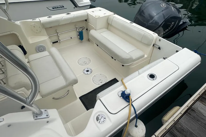 Slide: The Image of 2007 Pursuit 235 Denali LS boat interior with seating and Yamaha outboard motor. - 2