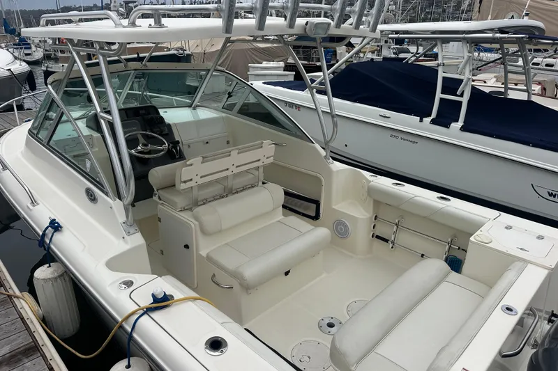 Slide: The Image of 2007 Pursuit 235 Denali LS boat with spacious seating, docked at a marina. - 4