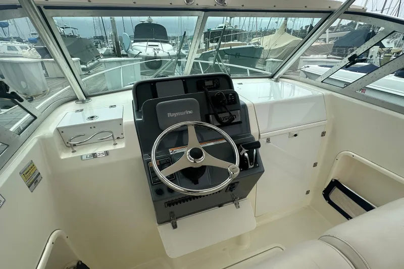 Slide: The Image of Helm of 2007 Pursuit 235 Denali LS boat with Raymarine equipment, docked at marina. - 6