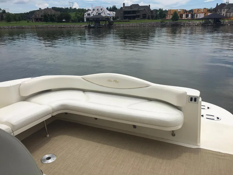 Slide: The Image of Luxurious seating on 2000 Sea Ray 410 Sundancer yacht, overlooking serene waterfront homes. - 13