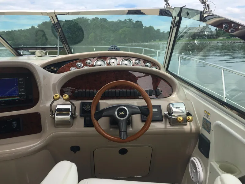 Slide: The Image of Helm of 2000 Sea Ray 410 Sundancer yacht with wooden steering wheel and control panel. - 16