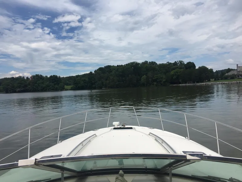 Slide: The Image of Bow view from a 2000 Sea Ray 410 Sundancer on a calm lake under a cloudy sky. - 20