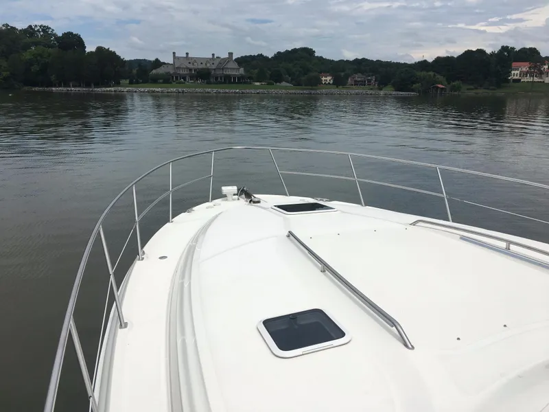 Slide: The Image of Bow view of 2000 Sea Ray 410 Sundancer on calm water near shoreline. - 23