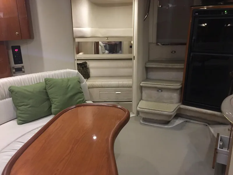 Slide: The Image of Interior of 2000 Sea Ray 410 Sundancer yacht with seating, table, and stairs. - 33