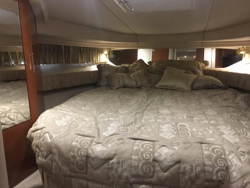 Slide: The Image of Luxurious cabin interior of 2000 Sea Ray 410 Sundancer yacht with plush bedding. - 36