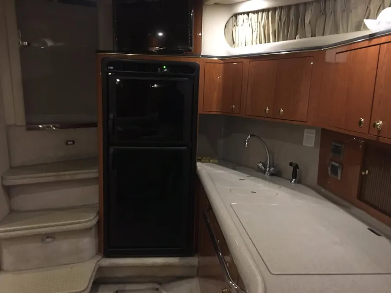 Slide: The Image of Interior of 2000 Sea Ray 410 Sundancer yacht with kitchenette and stairs. - 41