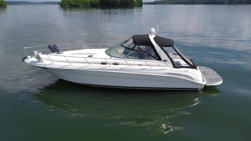 Slide: The Image of 2000 Sea Ray 410 Sundancer yacht on calm lake waters. - 47