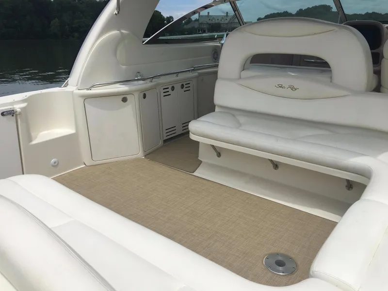 Slide: The Image of Luxurious interior of 2000 Sea Ray 410 Sundancer yacht with white seating and beige flooring. - 8