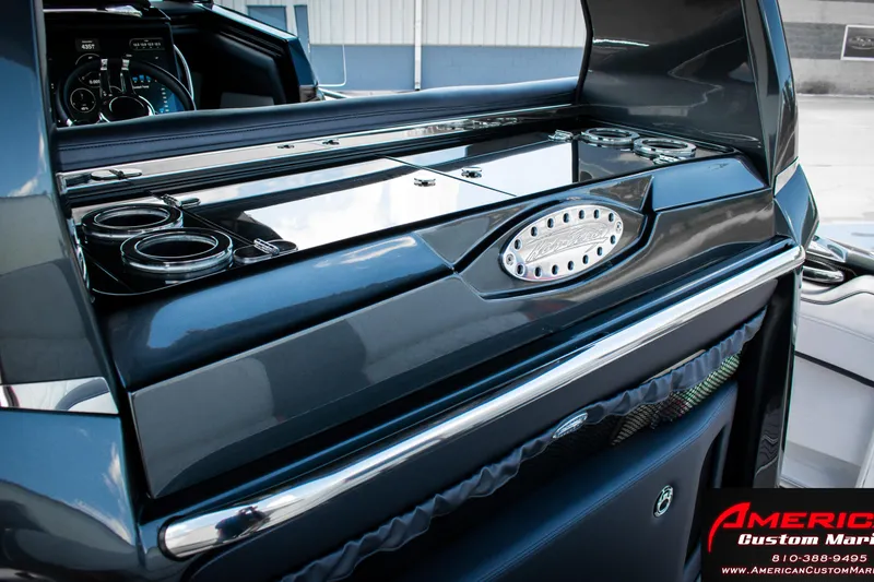 Slide: The Image of 2027 Nor-Tech 450 Sport Center Console interior with sleek design and cup holders. - 10