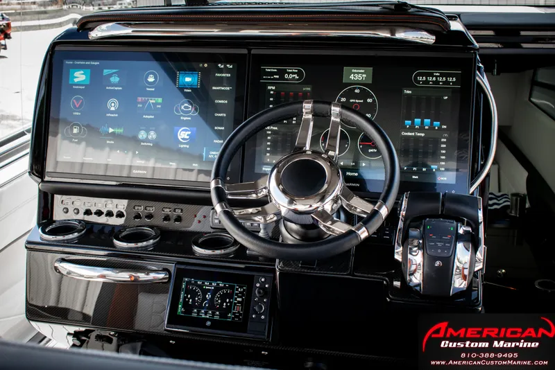 Slide: The Image of 2027 Nor-Tech 450 Sport Center Console dashboard with advanced digital controls and steering wheel. - 11