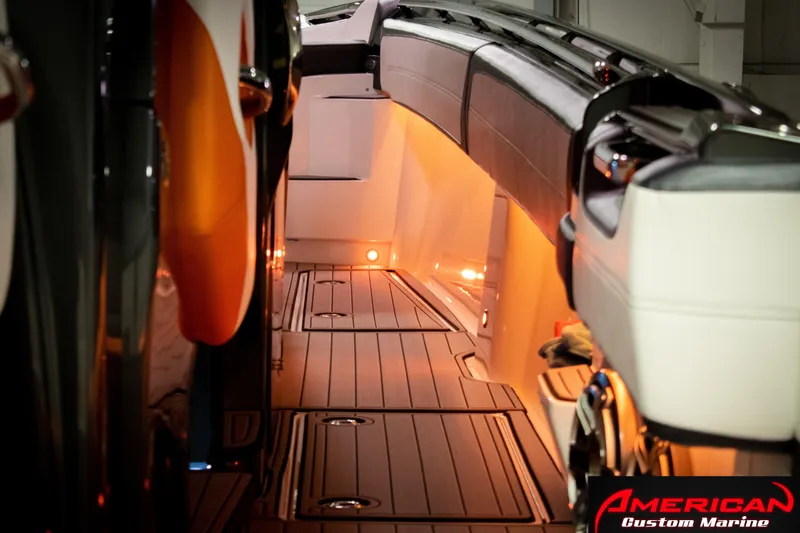 Slide: The Image of 2027 Nor-Tech 450 Sport Center Console interior with ambient lighting and sleek design. - 14