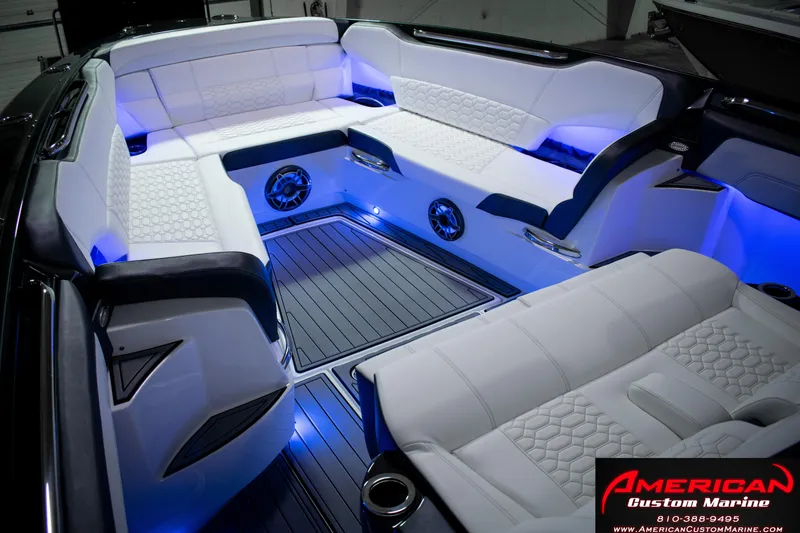 Slide: The Image of Luxurious interior of 2027 Nor-Tech 450 Sport Center Console with ambient blue lighting. - 15