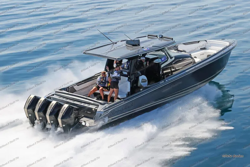 Slide: The Image of 2027 Nor-Tech 450 Sport Center Console speeding on water with passengers onboard. - 4