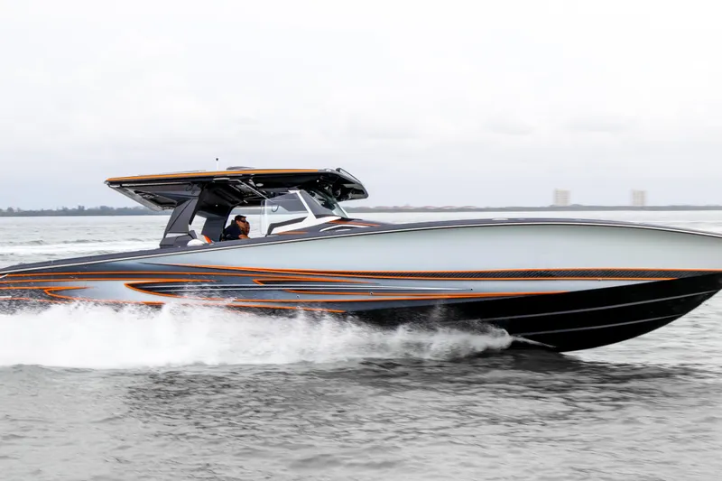 Slide: The Image of 2027 Nor-Tech 450 Sport Center Console speeding on water, showcasing sleek design and performance. - 6