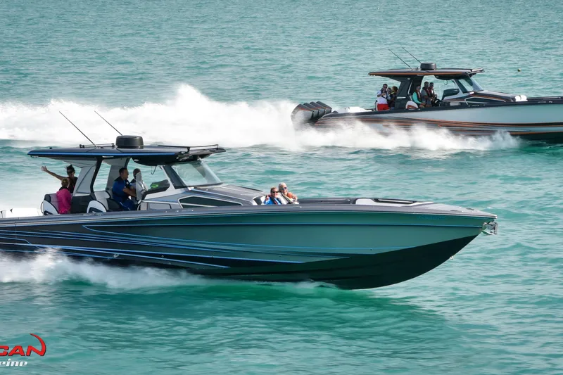 Slide: The Image of 2027 Nor-Tech 450 Sport Center Console boats cruising on turquoise water. - 7