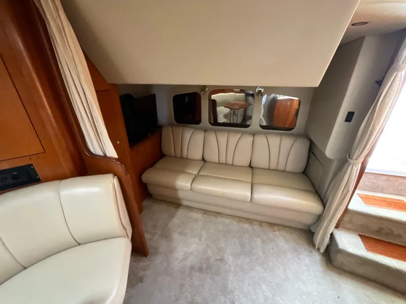Slide: The Image of Interior of 2004 Cruisers Yachts 370 Express with beige seating and mirrors. - 17