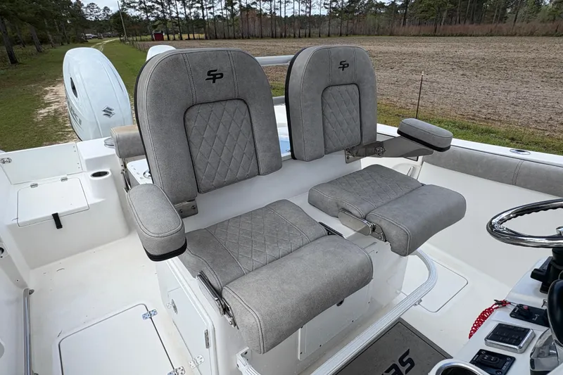 Slide: The Image of 2021 Sea Pro 259 DLX boat interior with dual gray cushioned seats. - 12