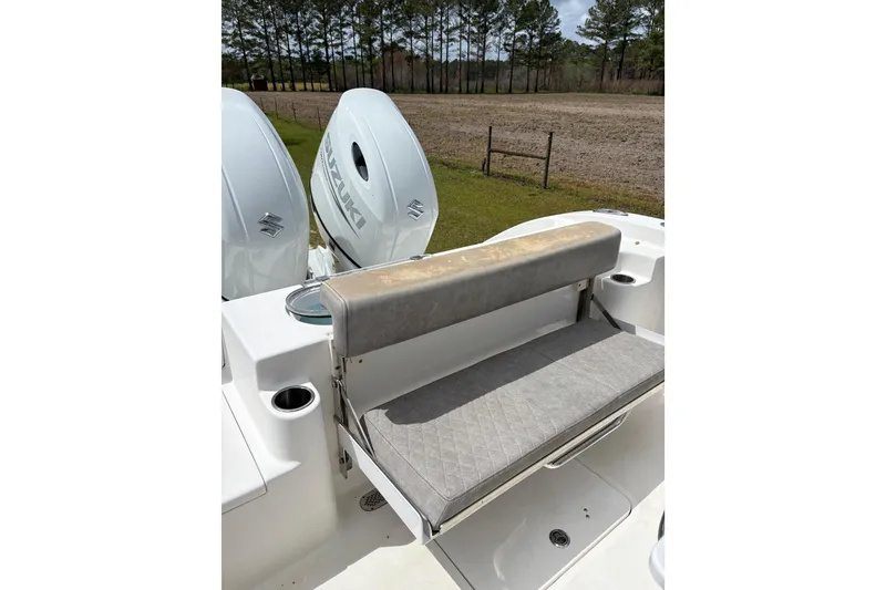 Slide: The Image of 2021 Sea Pro 259 DLX boat with Suzuki engines and cushioned seating. - 15