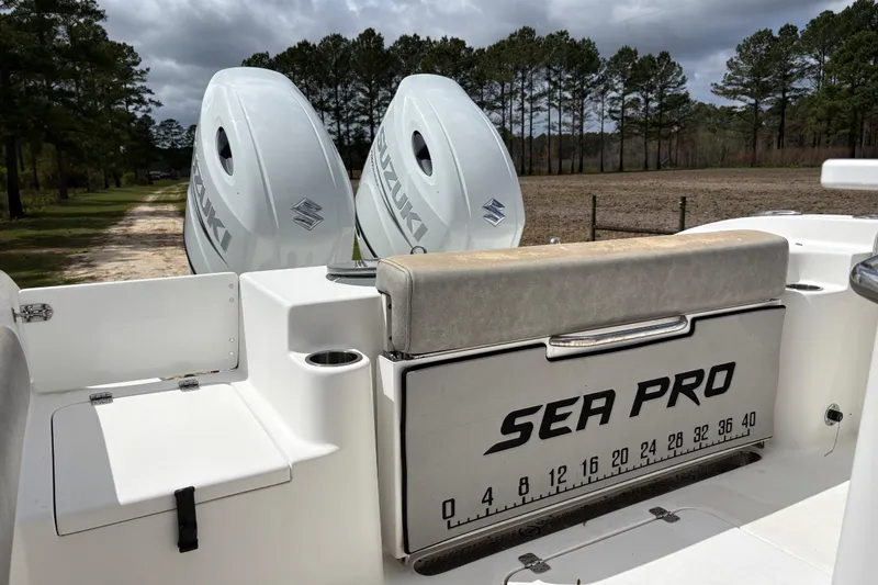 Slide: The Image of 2021 Sea Pro 259 DLX boat with Suzuki engines, parked outdoors. - 16