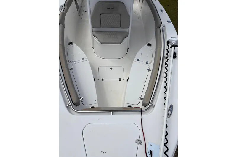 Slide: The Image of 2021 Sea Pro 259 DLX boat interior with seating and storage compartments. - 4
