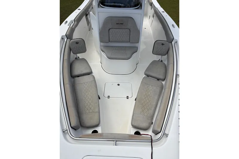 Slide: The Image of 2021 Sea Pro 259 DLX boat interior with cushioned seating and storage compartments. - 5